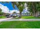Gray house with a green lawn, two parked cars visible at 901 S Solandra Dr, Orlando, FL 32807