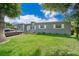 Gray house with a green lawn and driveway, parked car visible at 901 S Solandra Dr, Orlando, FL 32807