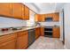 Kitchen with light wood cabinets, granite counters, and stainless steel appliances at 901 S Solandra Dr, Orlando, FL 32807