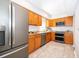 Kitchen with light wood cabinets, granite counters, and stainless steel appliances at 901 S Solandra Dr, Orlando, FL 32807