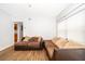 Living room with brown sectional sofa and wood floors at 901 S Solandra Dr, Orlando, FL 32807