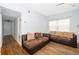 Living room with brown sectional sofa and wood floors at 901 S Solandra Dr, Orlando, FL 32807