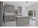 Modern kitchen with gray cabinets, quartz countertops and island at 13497 Se 100Th Ave, Belleview, FL 34420