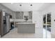 Modern kitchen with gray cabinets, quartz countertops and island at 13497 Se 100Th Ave, Belleview, FL 34420
