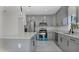 Modern kitchen with gray cabinets, quartz countertops, and island at 13497 Se 100Th Ave, Belleview, FL 34420