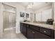 Modern bathroom with double vanity, granite countertop, and a shower at 1366 Lava Tree Dr, Davenport, FL 33897