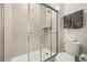 Clean bathroom with a large shower, toilet and plenty of storage at 1366 Lava Tree Dr, Davenport, FL 33897