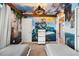 Themed bedroom with a mural and twin beds, perfect for  at 1366 Lava Tree Dr, Davenport, FL 33897