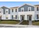 Two story townhouse with front yard and walkway at 1366 Lava Tree Dr, Davenport, FL 33897