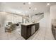 Open concept kitchen with granite island and stainless steel appliances at 1366 Lava Tree Dr, Davenport, FL 33897