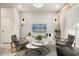 Living area featuring stylish armchairs, a coffee table and a large TV at 1366 Lava Tree Dr, Davenport, FL 33897