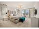 Luxurious main bedroom with plush bed, stylish decor, and large windows at 1366 Lava Tree Dr, Davenport, FL 33897