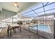 Enclosed pool area with patio furniture and screened enclosure at 1366 Lava Tree Dr, Davenport, FL 33897
