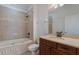 Bathroom features a tub and updated vanity at 13730 Lensdale Ln, Windermere, FL 34786