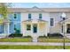 Charming two-story townhome with a welcoming front porch and well-maintained landscaping at 13730 Lensdale Ln, Windermere, FL 34786