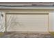 Attached garage with off-white door at 13730 Lensdale Ln, Windermere, FL 34786