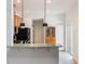 Kitchen with breakfast bar and modern pendant lighting at 13730 Lensdale Ln, Windermere, FL 34786