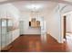 Open living area with hardwood floors and kitchen access at 13730 Lensdale Ln, Windermere, FL 34786
