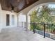 Spacious balcony with arched details, tile flooring and wrought iron railing at 141 Oakwood Way, Winter Park, FL 32789