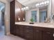 Modern bathroom with double vanity, large mirror, and ample storage at 141 Oakwood Way, Winter Park, FL 32789