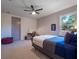 Bright bedroom with carpeted floor, built-in desk, and large window at 141 Oakwood Way, Winter Park, FL 32789
