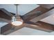 Close-up of a modern ceiling fan with dark wood beams at 141 Oakwood Way, Winter Park, FL 32789