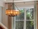 Elegant dining room chandelier over a window with curtains at 141 Oakwood Way, Winter Park, FL 32789