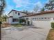 Two-story house with attached two-car garage and landscaping at 141 Oakwood Way, Winter Park, FL 32789