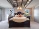 Spacious main bedroom with a dark wood bed frame and coffered ceiling at 141 Oakwood Way, Winter Park, FL 32789
