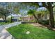 Charming home with a well-manicured lawn, palm trees, and a cozy front porch at 1426 Madison Ivy Cir, Apopka, FL 32712