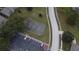 Aerial view of a community basketball court with parking and is surrounded by trees at 144 Reserve Cir # 112, Oviedo, FL 32765