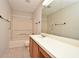 Neutral bathroom featuring a single vanity, tile floors, and a shower and tub combo with an updated shower head at 144 Reserve Cir # 112, Oviedo, FL 32765