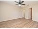 This bedroom has wood floors, a ceiling fan, and closet at 144 Reserve Cir # 112, Oviedo, FL 32765