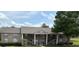 Multi-Gathering unit with brick accents, exterior stairs, and mature landscaping at 144 Reserve Cir # 112, Oviedo, FL 32765