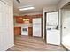 Kitchen features wood cabinets, white appliances, and vinyl flooring at 144 Reserve Cir # 112, Oviedo, FL 32765
