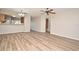 Open-concept living room with wood-look flooring that seamlessly flows into other rooms at 144 Reserve Cir # 112, Oviedo, FL 32765