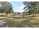 Community view of a pond with a small bridge, surrounded by trees at 144 Reserve Cir # 112, Oviedo, FL 32765