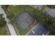 Aerial view of a tennis court with parking in a community surrounded by trees and maintained landscape at 144 Reserve Cir # 112, Oviedo, FL 32765