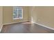 Bright bedroom features a large window and laminate wood floors at 15203 Starleigh Rd, Winter Garden, FL 34787