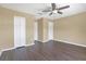 Spacious bedroom with dark laminate flooring and double door closet at 15203 Starleigh Rd, Winter Garden, FL 34787