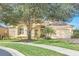 One story home with stone exterior and palm trees at 1554 Saint Regis Pt, Sanford, FL 32771