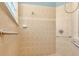 Walk-in shower with tiled walls and grab bars at 1554 Saint Regis Pt, Sanford, FL 32771