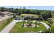 An aerial view showcasing a house with a three-car garage and lush landscaping at 1877 Crowley E Cir, Longwood, FL 32779