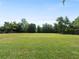 Large grassy backyard with mature trees at 1877 Crowley E Cir, Longwood, FL 32779