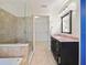 Bathroom with granite vanity, walk-in shower, and soaking tub at 1877 Crowley E Cir, Longwood, FL 32779