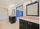 Double vanity bathroom with granite countertops and large mirrors at 1877 Crowley E Cir, Longwood, FL 32779
