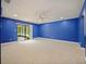 Bedroom with blue walls, ceiling fan, and access to patio at 1877 Crowley E Cir, Longwood, FL 32779