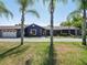 House exterior with palm trees and a driveway at 1877 Crowley E Cir, Longwood, FL 32779