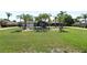 Blue house with palm trees and a manicured lawn at 1877 Crowley E Cir, Longwood, FL 32779