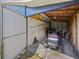 A cluttered garage with a lawnmower and other items at 1877 Crowley E Cir, Longwood, FL 32779